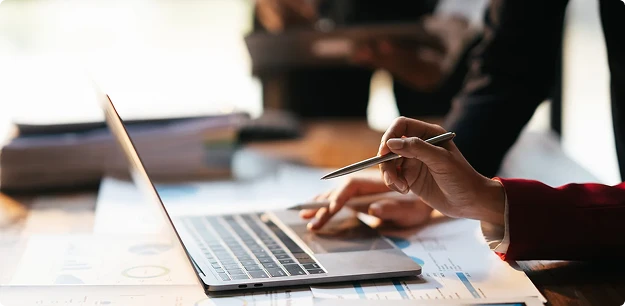 Business team analyzing data on a laptop