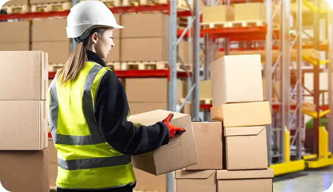 Woman with box in warehouse